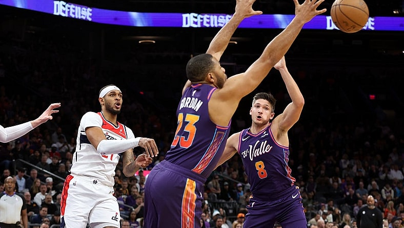 Dec 17, 2023; Phoenix, Arizona, USA; Phoenix Suns guard Eric Gordon (23) gets a steel from Washington Wizards center Daniel Gafford (21) during the first quarter at Footprint Center. Mandatory Credit: Zachary BonDurant-USA TODAY Sports