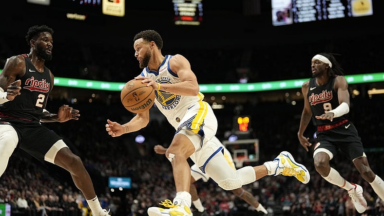 Dec 17, 2023; Portland, Oregon, USA; Golden State Warriors point guard Stephen Curry (30) dribbles the ball as Portland Trail Blazers center Deandre Anton (2) defends during the first half at Moda Center. Mandatory Credit: Soobum Im-USA TODAY Sports