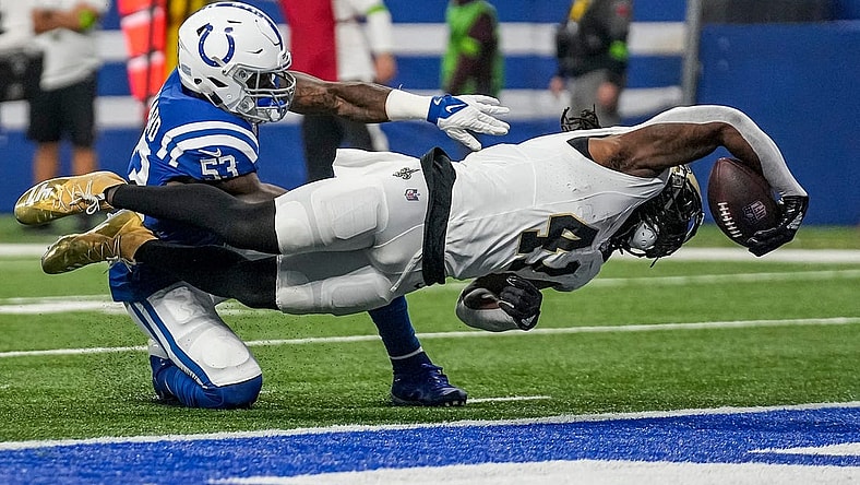 New Orleans Saints running back Alvin Kamara (41) dives for a touchdown, under defensive pressure from Indianapolis Colts linebacker Shaquille Leonard (53), on Sunday, Oct. 29, 2023, at Lucas Oil Stadium in Indianapolis.