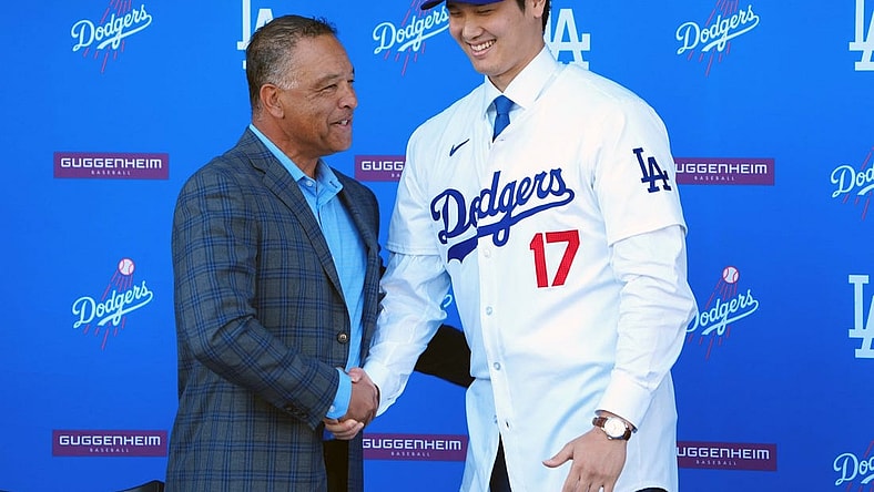 Dec 14, 2023; Los Angeles, CA, USA; Los Angeles Dodgers designated hitter Shohei Ohtani (17) shakes hands with manager Dave Roberts at press conference at Dodger Stadium. Mandatory Credit: Kirby Lee-USA TODAY Sports