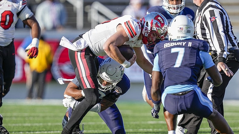Dec 18, 2023; Charlotte, NC, USA; Western Kentucky Hilltoppers quarterback Caden Veltkamp (10) runs the ball against the Old Dominion Monarchs during the first quarter at Charlotte 49ers' Jerry Richardson Stadium. Mandatory Credit: Jim Dedmon-USA TODAY Sports