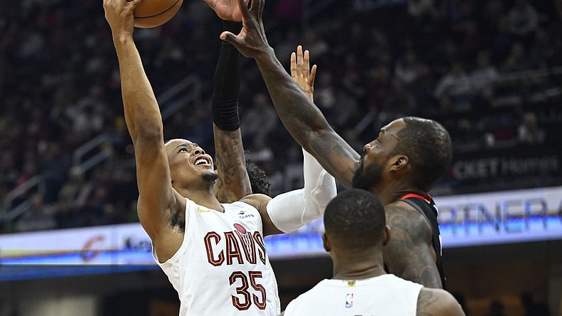Dec 18, 2023; Cleveland, Ohio, USA; Cleveland Cavaliers forward Isaac Okoro (35) drives to the basket beside Houston Rockets forward Jeff Green (32) in the second quarter at Rocket Mortgage FieldHouse. Mandatory Credit: David Richard-USA TODAY Sports