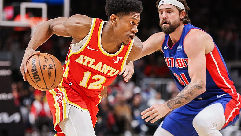 Dec 18, 2023; Atlanta, Georgia, USA; Atlanta Hawks forward De'Andre Hunter (12) drives on Detroit Pistons forward Joe Harris (31) in the second quarter at State Farm Arena. Mandatory Credit: Brett Davis-USA TODAY Sports