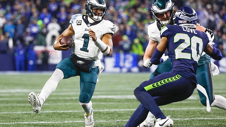 Dec 18, 2023; Seattle, Washington, USA; Philadelphia Eagles quarterback Jalen Hurts (1) rushes against the Seattle Seahawks during the second quarter at Lumen Field. Mandatory Credit: Joe Nicholson-USA TODAY Sports