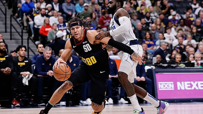 Dec 18, 2023; Denver, Colorado, USA; Denver Nuggets forward Aaron Gordon (50) controls the ball as Dallas Mavericks forward Tim Hardaway Jr. (10) guards in the second quarter at Ball Arena. Mandatory Credit: Isaiah J. Downing-USA TODAY Sports