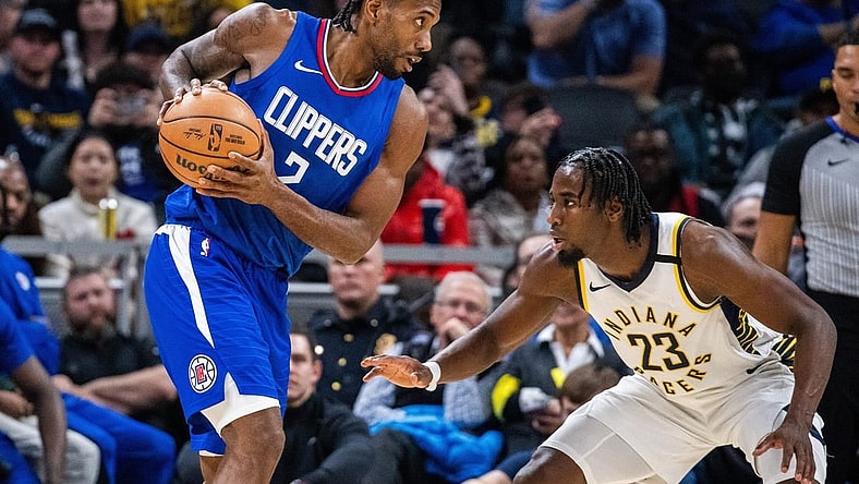 Dec 18, 2023; Indianapolis, Indiana, USA;  LA Clippers forward Kawhi Leonard (2) holds the ball while Indiana Pacers forward Aaron Nesmith (23) defends in the second half at Gainbridge Fieldhouse. Mandatory Credit: Trevor Ruszkowski-USA TODAY Sports