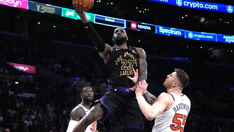 Dec 18, 2023; Los Angeles, California, USA; Los Angeles Lakers forward LeBron James (23) shoots the ball against New York Knicks center Isaiah Hartenstein (55) in the second half at Crypto.com Arena. Mandatory Credit: Kirby Lee-USA TODAY Sports