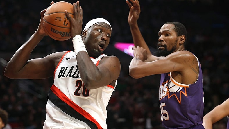 Dec 19, 2023; Portland, Oregon, USA;  Portland Trail Blazers center Duop Reath (26) grabs a rebound against Phoenix Suns forward Kevin Durant (35) in the first half at Moda Center. Mandatory Credit: Jaime Valdez-USA TODAY Sports