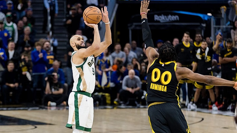 Dec 19, 2023; San Francisco, California, USA; Boston Celtics guard Derrick White (9) shoots over Golden State Warriors forward Jonathan Kuminga (00) during the second half at Chase Center. Mandatory Credit: John Hefti-USA TODAY Sports