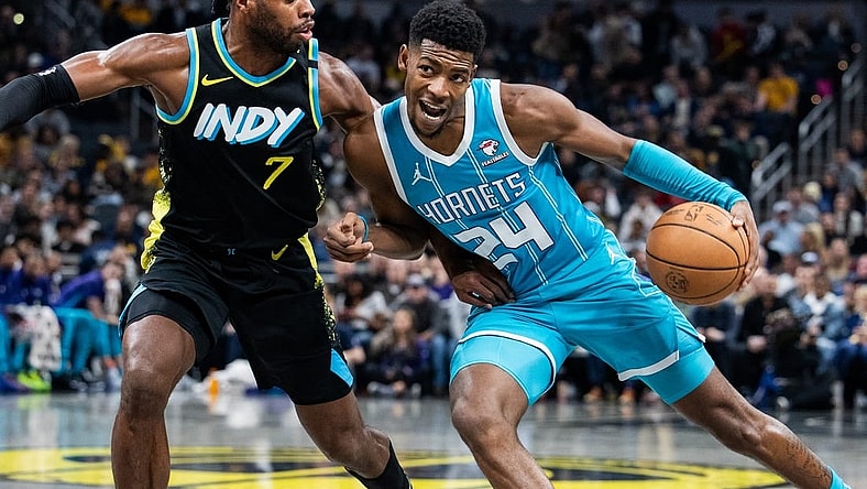 Dec 20, 2023; Indianapolis, Indiana, USA; Charlotte Hornets forward Brandon Miller (24) dribbles the ball while Indiana Pacers guard Buddy Hield (7) defends in the second quarter at Gainbridge Fieldhouse. Mandatory Credit: Trevor Ruszkowski-USA TODAY Sports