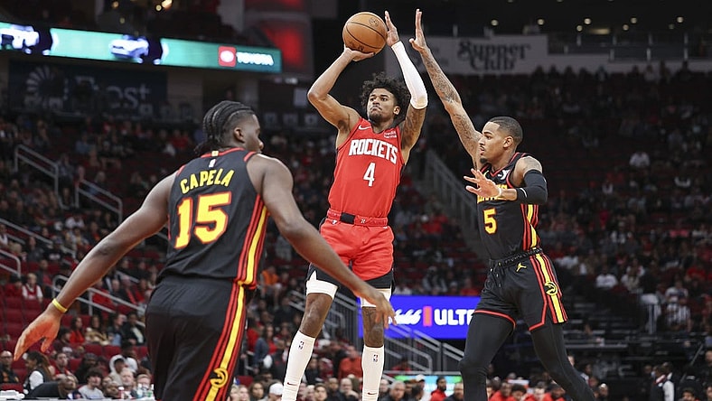Dec 20, 2023; Houston, Texas, USA; Houston Rockets guard Jalen Green (4) shoots the ball as Atlanta Hawks guard Dejounte Murray (5) defends during the first quarter at Toyota Center. Mandatory Credit: Troy Taormina-USA TODAY Sports