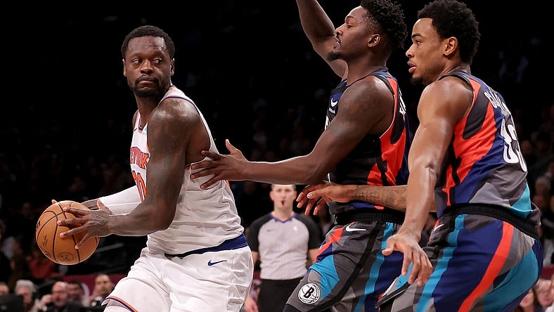 Dec 20, 2023; Brooklyn, New York, USA; New York Knicks forward Julius Randle (30) controls the ball against Brooklyn Nets forward Dorian Finney-Smith (28) and center Nic Claxton (33) during the first quarter at Barclays Center. Mandatory Credit: Brad Penner-USA TODAY Sports