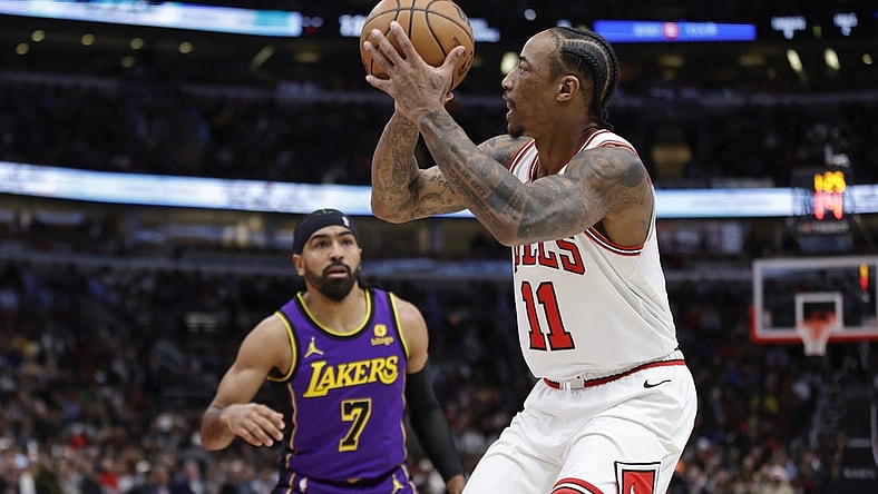Dec 20, 2023; Chicago, Illinois, USA; Chicago Bulls forward DeMar DeRozan (11) shoots against Los Angeles Lakers guard Gabe Vincent (7) during the first half at United Center. Mandatory Credit: Kamil Krzaczynski-USA TODAY Sports