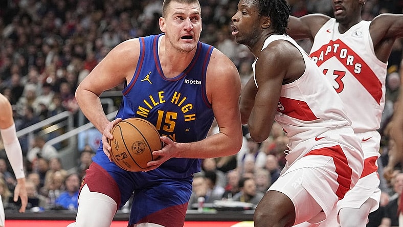 Dec 20, 2023; Toronto, Ontario, CAN; Denver Nuggets center Nikola Jokic (15) drives to the net against Toronto Raptors forward O.G. Anunoby (3) during the first half at Scotiabank Arena. Mandatory Credit: John E. Sokolowski-USA TODAY Sports
