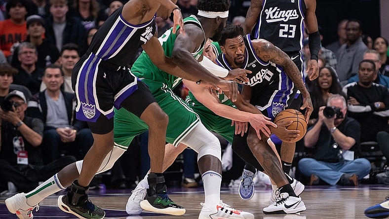 Dec 20, 2023; Sacramento, California, USA; Sacramento Kings guard Malik Monk (0) and Boston Celtics guard Payton Pritchard (11) fight for possession of the ball during the first quarter at Golden 1 Center. Mandatory Credit: Ed Szczepanski-USA TODAY Sports