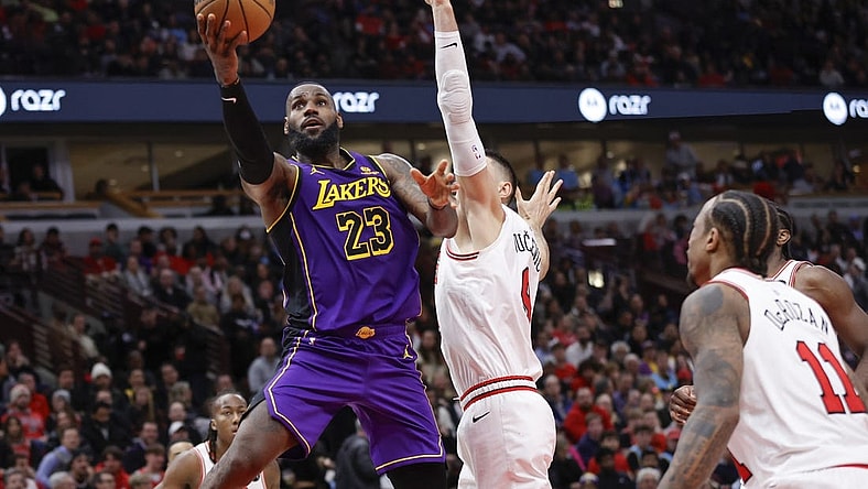 Dec 20, 2023; Chicago, Illinois, USA; Los Angeles Lakers forward LeBron James (23) goes to the basket against Chicago Bulls center Nikola Vucevic (9) during the second half at United Center. Mandatory Credit: Kamil Krzaczynski-USA TODAY Sports