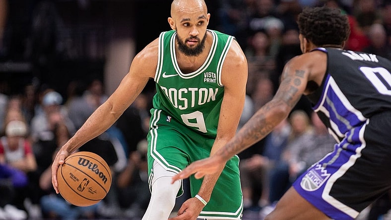 Dec 20, 2023; Sacramento, California, USA; Boston Celtics guard Derrick White (9) controls the ball against Sacramento Kings guard Malik Monk (0) during the fourth quarter at Golden 1 Center. Mandatory Credit: Ed Szczepanski-USA TODAY Sports