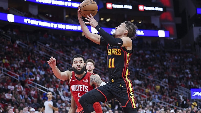 Dec 20, 2023; Houston, Texas, USA; Atlanta Hawks guard Trae Young (11) drives with the ball on a fast break as Houston Rockets guard Fred VanVleet (5) defends during the fourth quarter at Toyota Center. Mandatory Credit: Troy Taormina-USA TODAY Sports