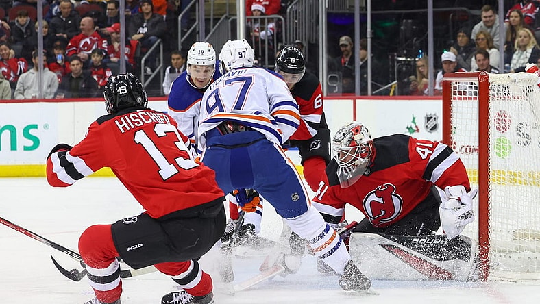 Dec 21, 2023; Newark, New Jersey, USA; New Jersey Devils goaltender Vitek Vanecek (41) makes a save on Edmonton Oilers center Connor McDavid (97) during the first period at Prudential Center. Mandatory Credit: Ed Mulholland-USA TODAY Sports