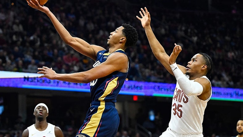 Dec 21, 2023; Cleveland, Ohio, USA; New Orleans Pelicans guard Trey Murphy III (25) drives to the basket beside Cleveland Cavaliers forward Isaac Okoro (35) in the second quarter at Rocket Mortgage FieldHouse. Mandatory Credit: David Richard-USA TODAY Sports