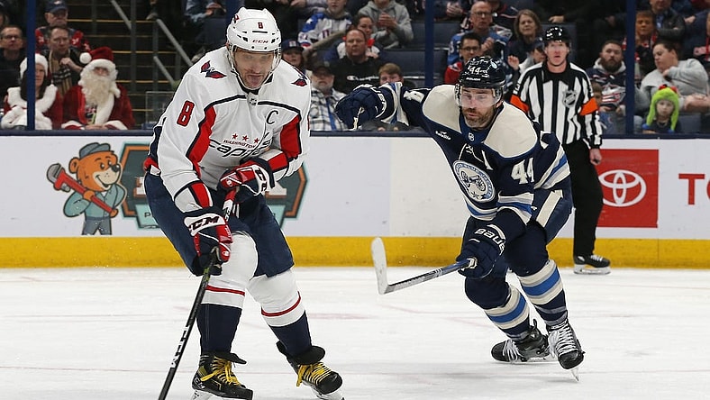 Dec 21, 2023; Columbus, Ohio, USA; Washington Capitals left wing Alex Ovechkin (8) wrists a shot on goal as Columbus Blue Jackets defenseman Erik Gudbranson (44) during the second period at Nationwide Arena. Mandatory Credit: Russell LaBounty-USA TODAY Sports