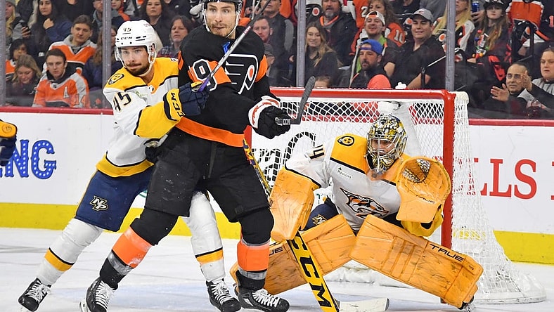 Dec 21, 2023; Philadelphia, Pennsylvania, USA; Philadelphia Flyers right wing Garnet Hathaway (19) and Nashville Predators defenseman Alexandre Carrier (45) battle for the puck in front of goaltender Juuse Saros (74) during the second period at Wells Fargo Center. Mandatory Credit: Eric Hartline-USA TODAY Sports