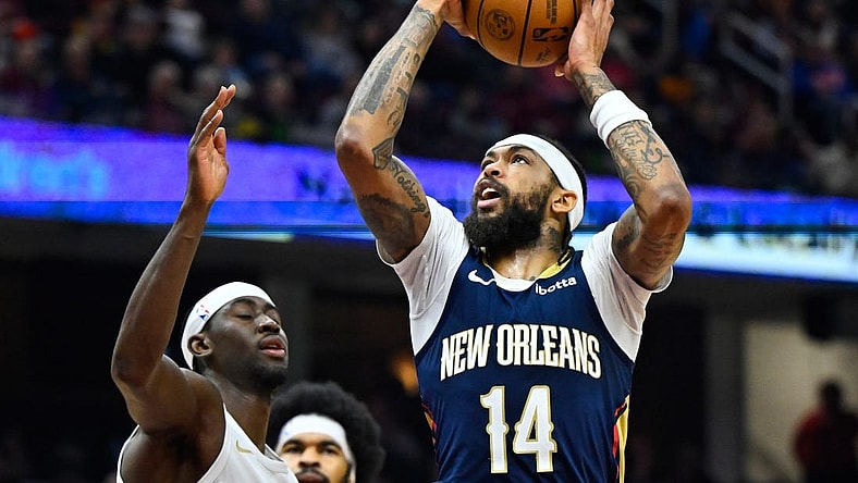 Dec 21, 2023; Cleveland, Ohio, USA; New Orleans Pelicans forward Brandon Ingram (14) drives against Cleveland Cavaliers guard Caris LeVert (3) in the second quarter at Rocket Mortgage FieldHouse. Mandatory Credit: David Richard-USA TODAY Sports