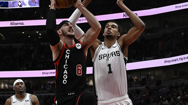 Dec 21, 2023; Chicago, Illinois, USA;  Chicago Bulls guard Alex Caruso (6) shoots against San Antonio Spurs center Victor Wembanyama (1) during the first half at the United Center. Mandatory Credit: Matt Marton-USA TODAY Sports