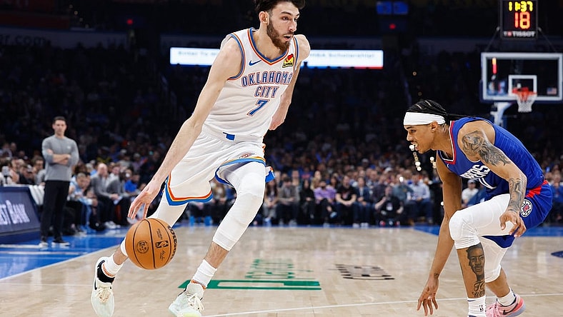Dec 21, 2023; Oklahoma City, Oklahoma, USA; Oklahoma City Thunder forward Chet Holmgren (7) drives to the basket against LA Clippers guard Brandon Boston Jr. (4) during the second quarter at Paycom Center. Mandatory Credit: Alonzo Adams-USA TODAY Sports