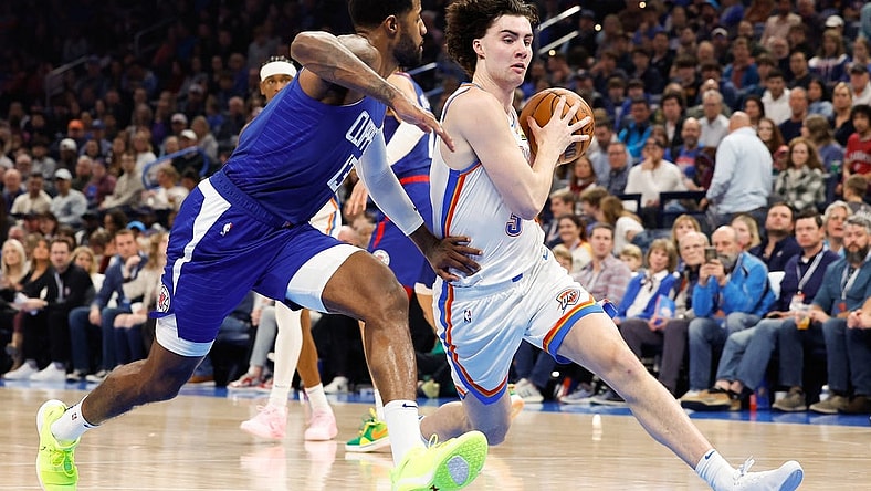Dec 21, 2023; Oklahoma City, Oklahoma, USA; Oklahoma City Thunder guard Josh Giddey (3) drives past LA Clippers forward Paul George (13) during the second quarter at Paycom Center. Mandatory Credit: Alonzo Adams-USA TODAY Sports