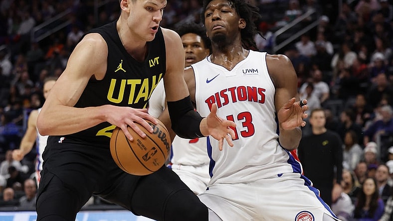 Dec 21, 2023; Detroit, Michigan, USA;  Utah Jazz center Walker Kessler (24) is defended by Detroit Pistons center James Wiseman (13) in the second half at Little Caesars Arena. Mandatory Credit: Rick Osentoski-USA TODAY Sports