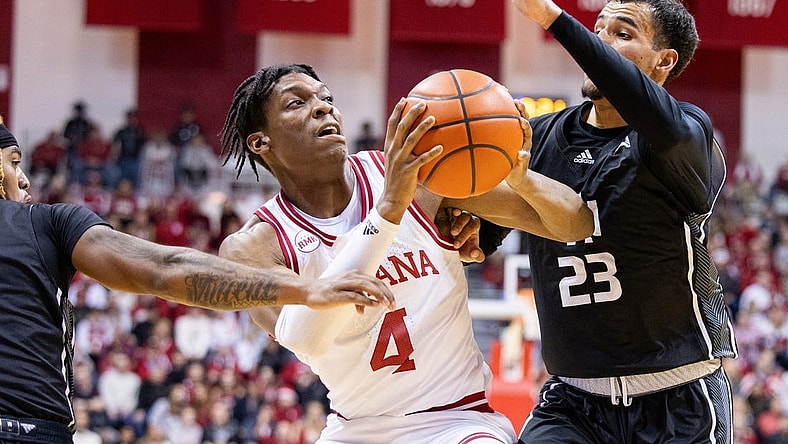 Dec 21, 2023; Bloomington, Indiana, USA; Indiana Hoosiers forward Anthony Walker (4) dribbles the ball as North Alabama Lions forward Tim Smith Jr. (23) defends in the first half at Simon Skjodt Assembly Hall. Mandatory Credit: Trevor Ruszkowski-USA TODAY Sports