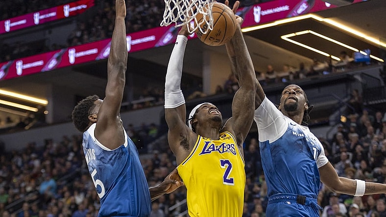 Dec 21, 2023; Minneapolis, Minnesota, USA; Minnesota Timberwolves center Naz Reid (11) jumps up and blocks a shot from Los Angeles Lakers forward Jarred Vanderbilt (2) as Minnesota Timberwolves guard Anthony Edwards (5) plays defense in the first half at Target Center. Mandatory Credit: Jesse Johnson-USA TODAY Sports