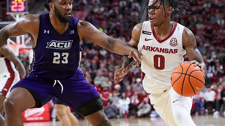 Dec 21, 2023; Fayetteville, Arkansas, USA; Arkansas Razorbacks guard Khalif Battle (0) drives against Abilene Christian Wildcats forward Airion Simmons (23) during the second half at Bud Walton Arena. Arkansas won 83-73. Mandatory Credit: Nelson Chenault-USA TODAY Sports