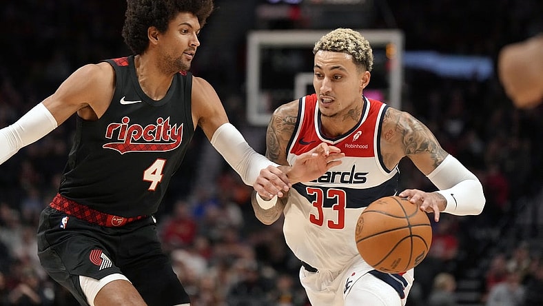 Dec 21, 2023; Portland, Oregon, USA; Washington Wizards small forward Kyle Kuzma (33) dribbles the ball as Portland Trail Blazers shooting guard Matisse Thybulle (4) defends during the first half at Moda Center. Mandatory Credit: Soobum Im-USA TODAY Sports