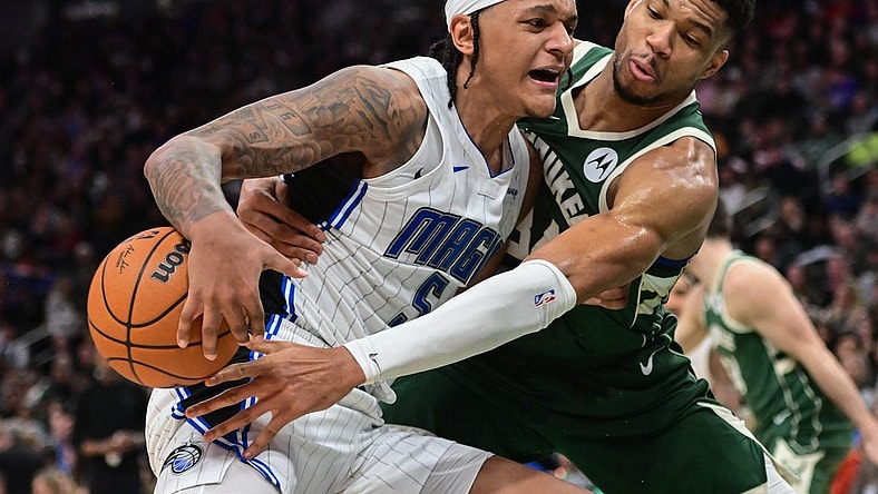 Dec 21, 2023; Milwaukee, Wisconsin, USA; Milwaukee Bucks forward Giannis Antetokounmpo (34) tries to steal the ball from Orlando Magic forward Paolo Banchero (5) in the third quarter at Fiserv Forum. Mandatory Credit: Benny Sieu-USA TODAY Sports