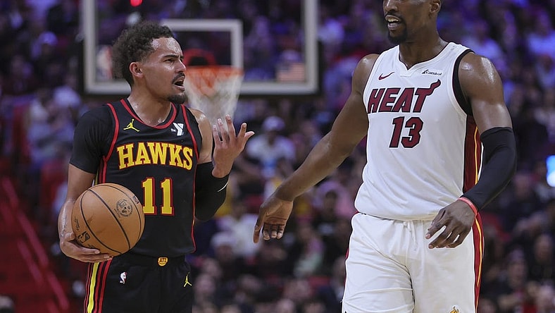 Dec 22, 2023; Miami, Florida, USA; Atlanta Hawks guard Trae Young (11) and Miami Heat center Bam Adebayo (13) talk during the second quarter at Kaseya Center. Mandatory Credit: Sam Navarro-USA TODAY Sports