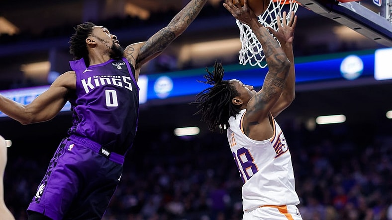 Dec 22, 2023; Sacramento, California, USA; Sacramento Kings guard Malik Monk (0) blocks a shot by Phoenix Suns guard Saben Lee (38) during the second quarter at Golden 1 Center. Mandatory Credit: Sergio Estrada-USA TODAY Sports
