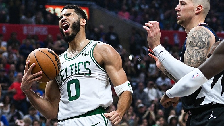 Dec 23, 2023; Los Angeles, California, USA; Boston Celtics forward Jayson Tatum (0) celebrates after scoring against Los Angeles Clippers center Daniel Theis (10) during the first quarter at Crypto.com Arena. Mandatory Credit: Jonathan Hui-USA TODAY Sports
