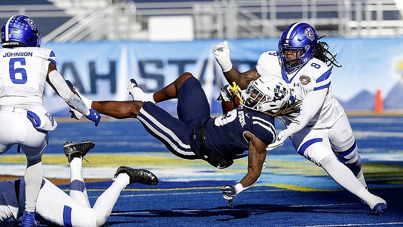 Dec 23, 2023; Boise, ID, USA; Utah State Aggies running back Rahsul Faison (3) is tackled during the first half against the Georgia State Panthers at Albertsons Stadium. Mandatory Credit: Brian Losness-USA TODAY Sports