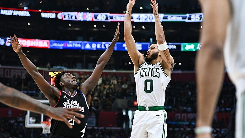 Dec 23, 2023; Los Angeles, California, USA; Boston Celtics forward Jayson Tatum (0) shoots against Los Angeles Clippers forward Kobe Brown (21) during the second quarter at Crypto.com Arena. Mandatory Credit: Jonathan Hui-USA TODAY Sports