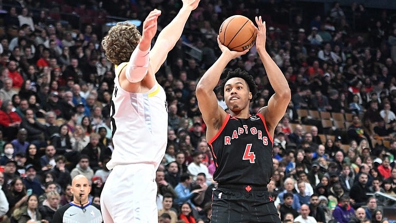 Dec 23, 2023; Toronto, Ontario, CAN;  Toronto Raptors forward Scottie Barnes (4) shoots the ball as Utah Jazz forward Lauri Markkanen (23) defends in the first half at Scotiabank Arena. Mandatory Credit: Dan Hamilton-USA TODAY Sports