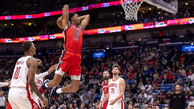 Dec 23, 2023; New Orleans, Louisiana, USA;  New Orleans Pelicans guard Trey Murphy III (25) dunks against Houston Rockets forward Jabari Smith Jr. (10) during the first half at Smoothie King Center. Mandatory Credit: Stephen Lew-USA TODAY Sports