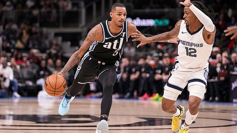 Dec 23, 2023; Atlanta, Georgia, USA; Atlanta Hawks guard Dejounte Murray (5) dribbles against Memphis Grizzlies guard Ja Morant (12) during the first half at State Farm Arena. Mandatory Credit: Dale Zanine-USA TODAY Sports