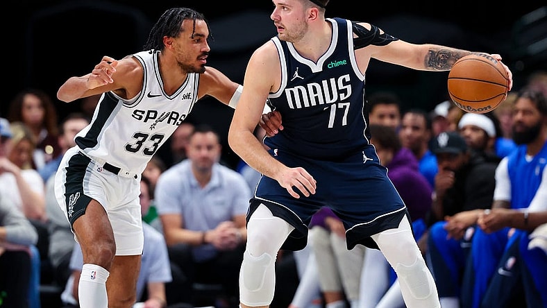 Dec 23, 2023; Dallas, Texas, USA; Dallas Mavericks guard Luka Doncic (77) controls the ball as San Antonio Spurs guard Tre Jones (33) defends during the second quarter at American Airlines Center. Mandatory Credit: Kevin Jairaj-USA TODAY Sports