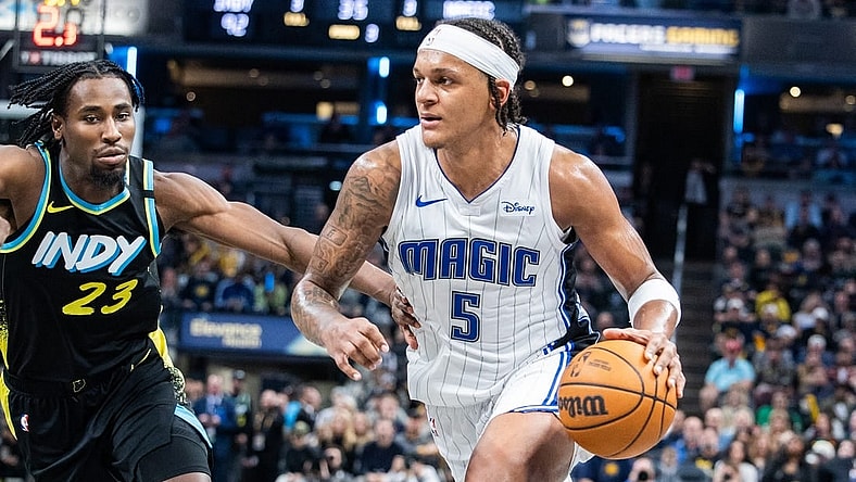 Dec 23, 2023; Indianapolis, Indiana, USA; Orlando Magic forward Paolo Banchero (5) dribbles the ball while Indiana Pacers forward Aaron Nesmith (23) defends in the second half at Gainbridge Fieldhouse. Mandatory Credit: Trevor Ruszkowski-USA TODAY Sports