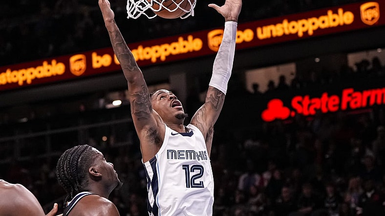 Dec 23, 2023; Atlanta, Georgia, USA; Memphis Grizzlies guard Ja Morant (12) dunks against the Atlanta Hawks during the second half  at State Farm Arena. Mandatory Credit: Dale Zanine-USA TODAY Sports