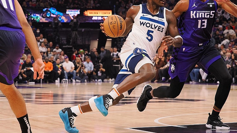 Dec 23, 2023; Sacramento, California, USA; Minnesota Timberwolves guard Anthony Edwards (5) drives in against Sacramento Kings forward Keegan Murray (13) during the first quarter at Golden 1 Center. Mandatory Credit: Kelley L Cox-USA TODAY Sports