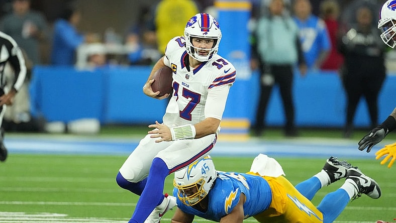 Dec 23, 2023; Inglewood, California, USA; Buffalo Bills quarterback Josh Allen (17) carries the ball against Los Angeles Chargers linebacker Tuli Tuipulotu (45) in the first half at SoFi Stadium. Mandatory Credit: Kirby Lee-USA TODAY Sports
