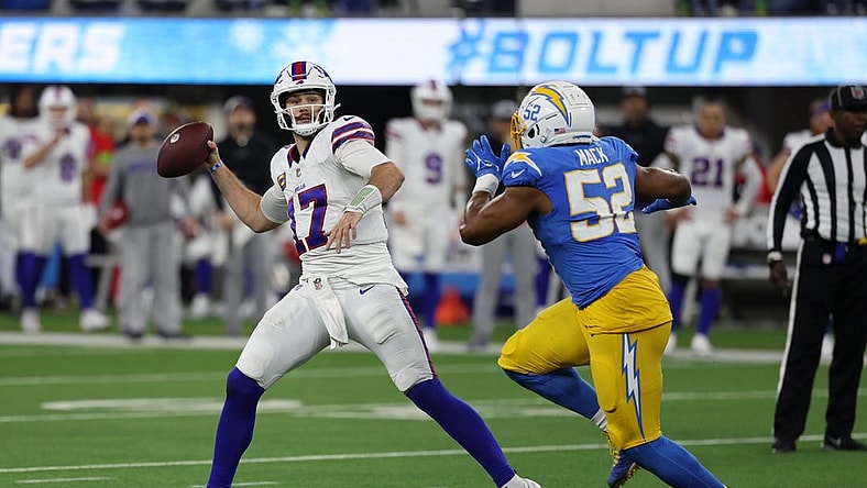 Dec 23, 2023; Inglewood, California, USA;  Buffalo Bills quarterback Josh Allen (17) throws a pass while Los Angeles Chargers linebacker Khalil Mack (52) pressuring him during the fourth quarter at SoFi Stadium. Mandatory Credit: Kiyoshi Mio-USA TODAY Sports